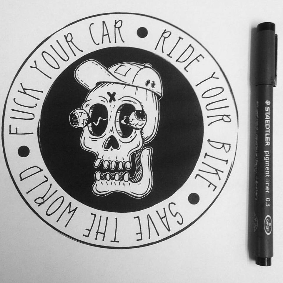 A drawn sticker with a skull wearing a baseball cap and it's eyes popping out in the middle

It says around the edge:
Fuck your car - Ride your bike - Save the world