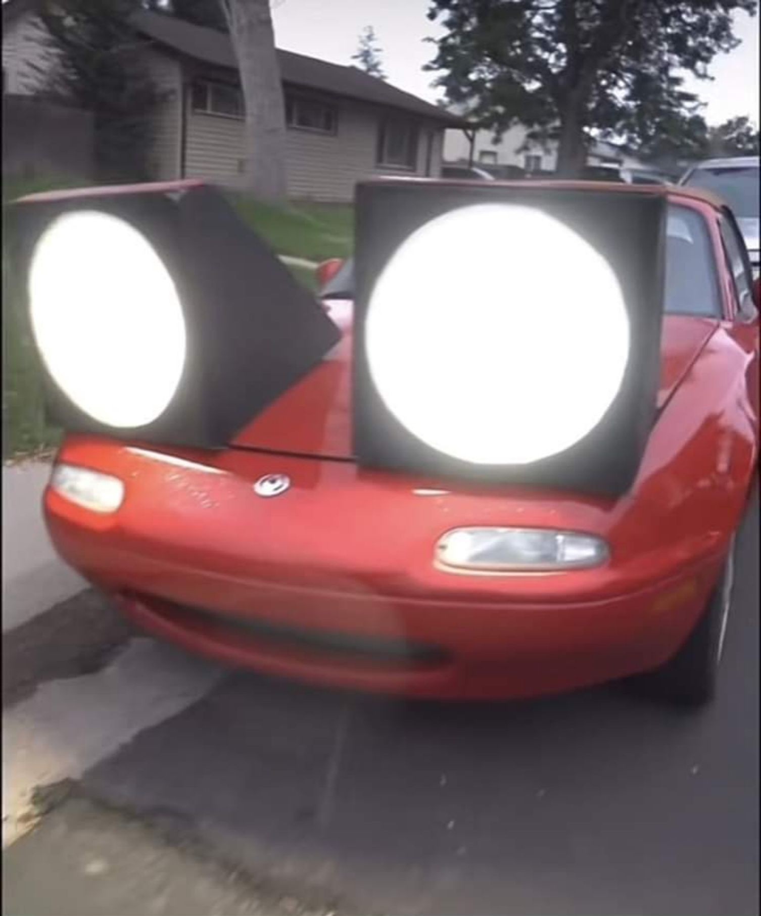 A Mazda MX-5 Miata where they've made the pop-up headlights enormous