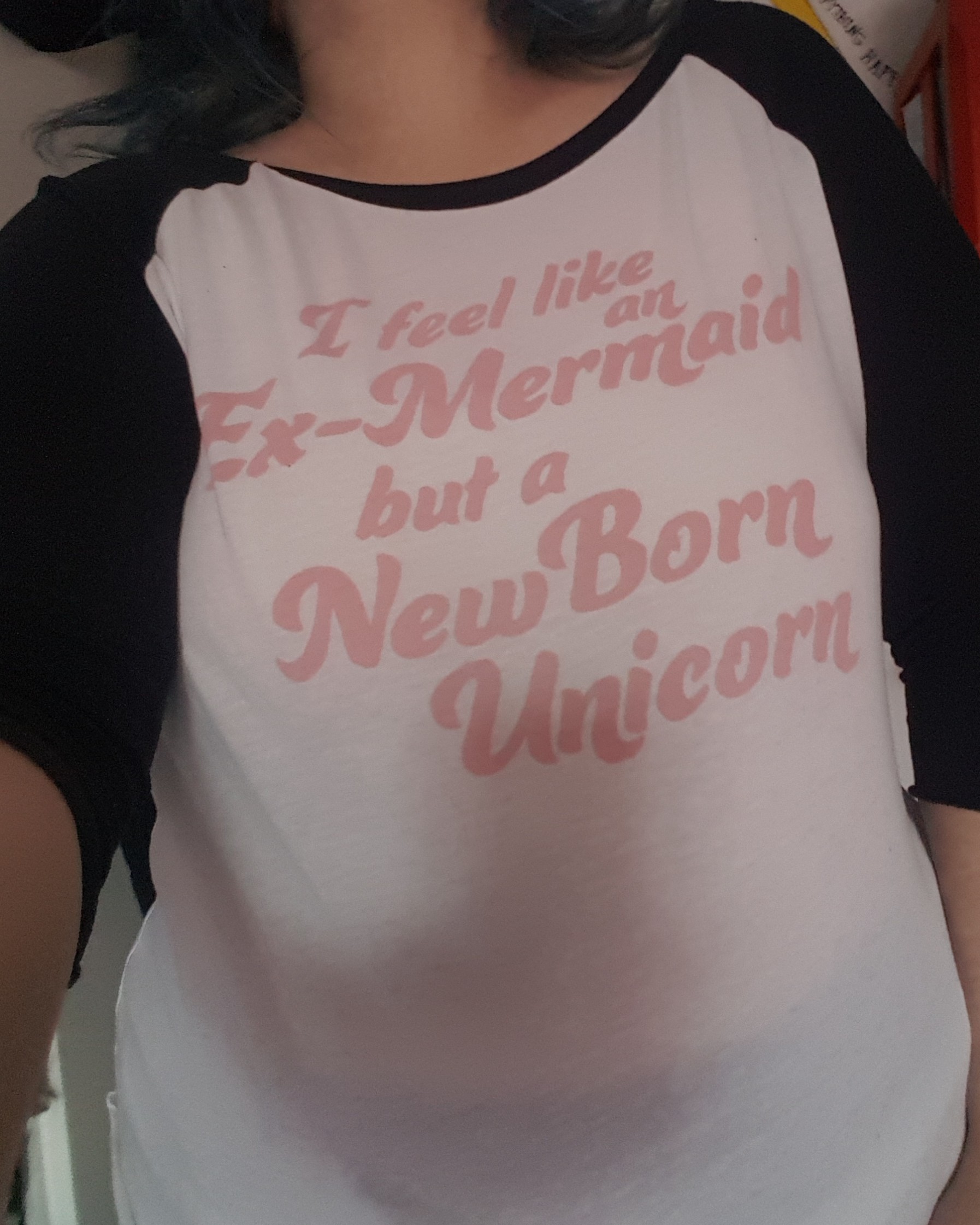 Oversized white kids shirt with black sleeves and pink print saying
I feel like an ex-mermaid but a new born unicorn 