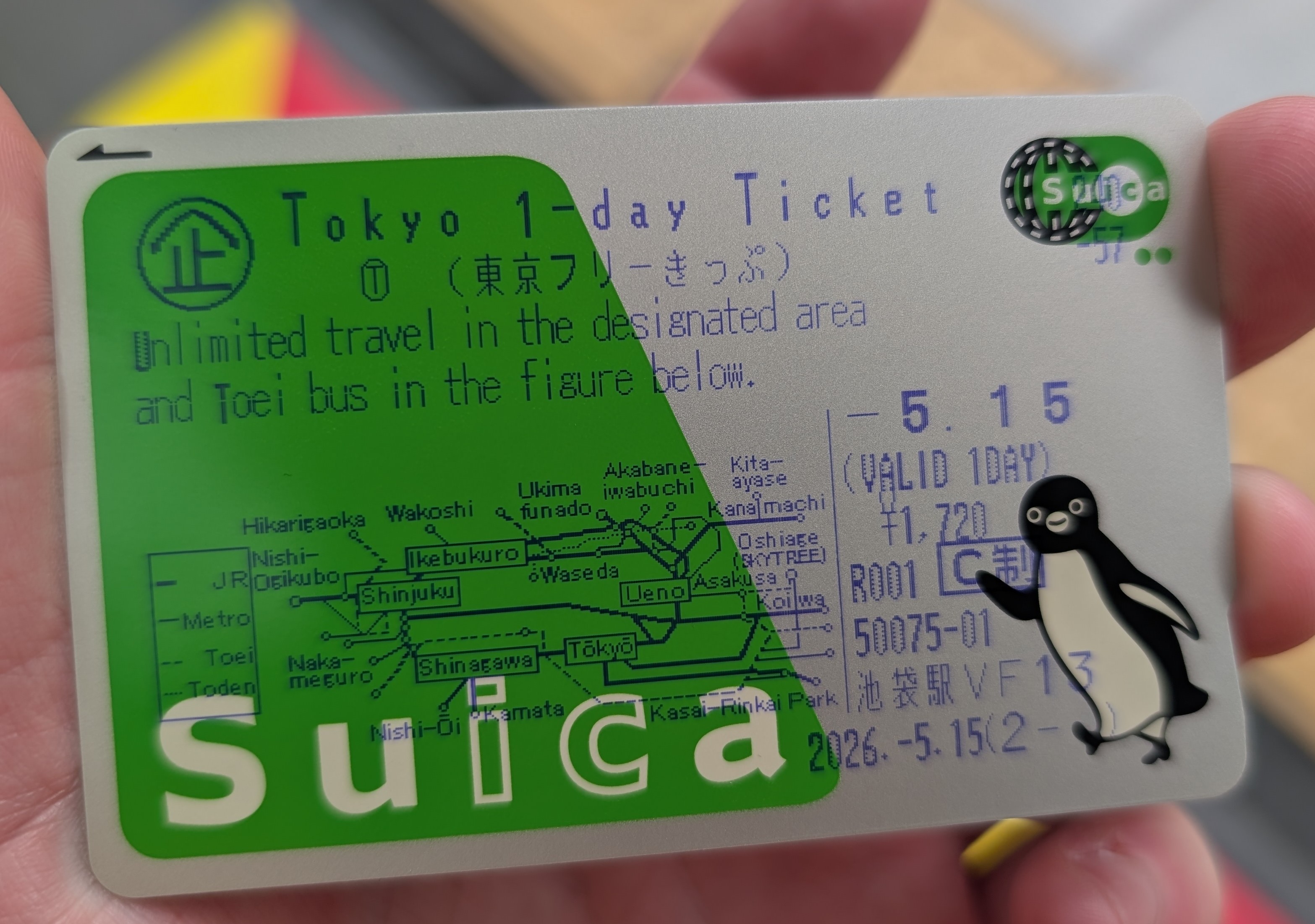 A Suica card. Over the top appears to be a blue printed ticket - it's a Tokyo 1-day ticket. 