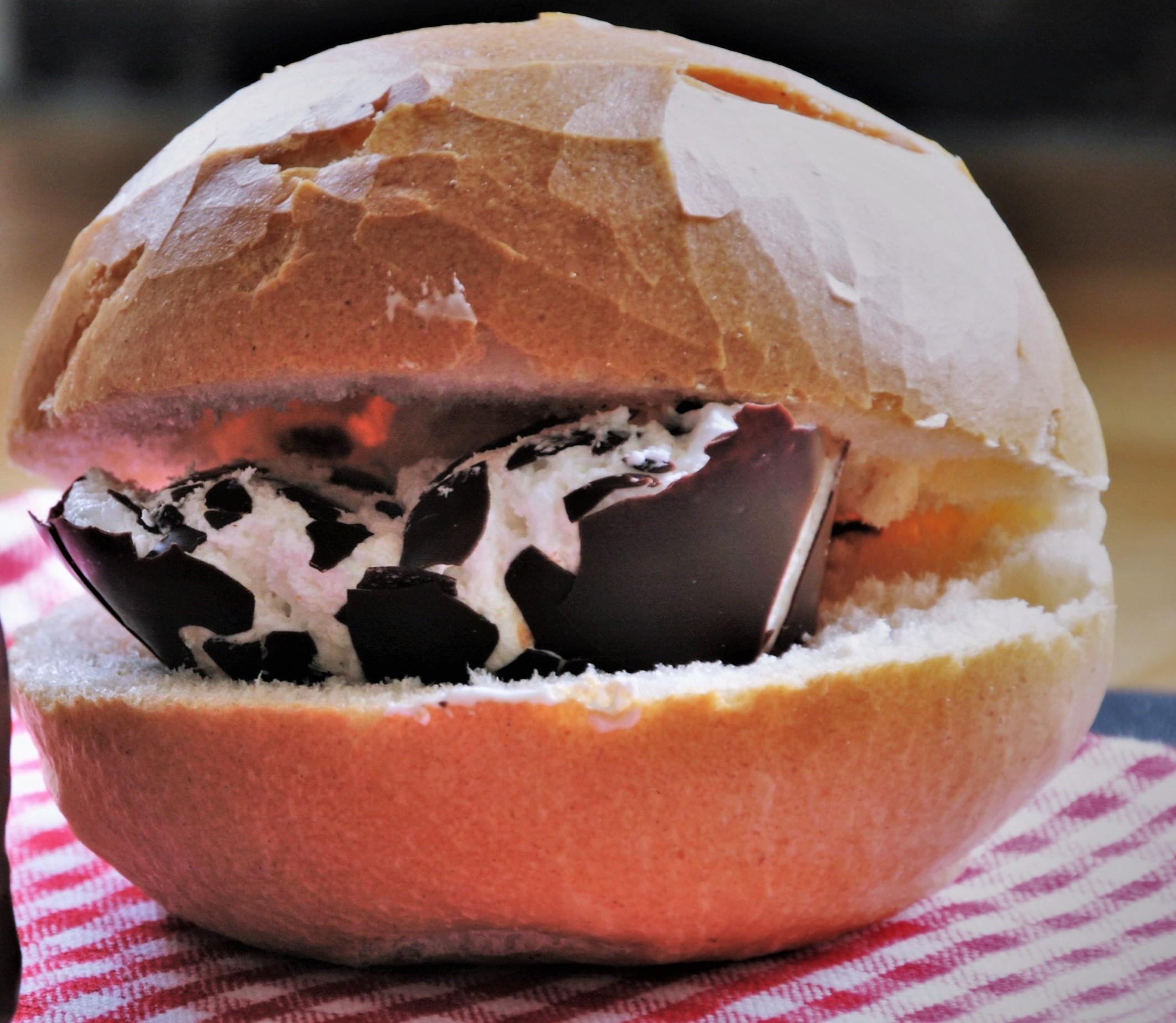 A German bun with a Schokokuss (which literally translates to "Choco-Kiss", a chocolate covered sugar cream on a wafer) inside.