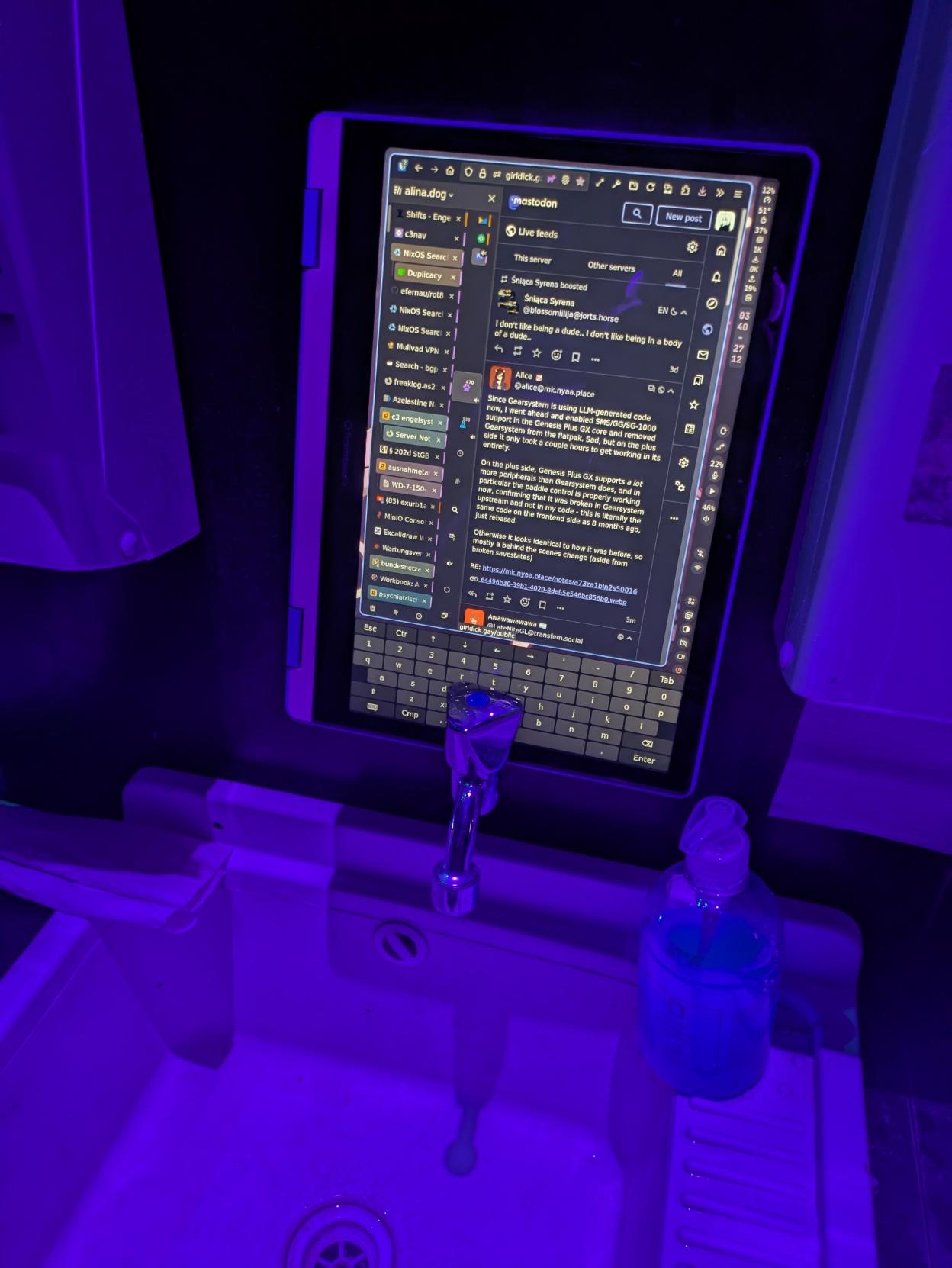 my framework 12 laptop balanced above a water drain in black light