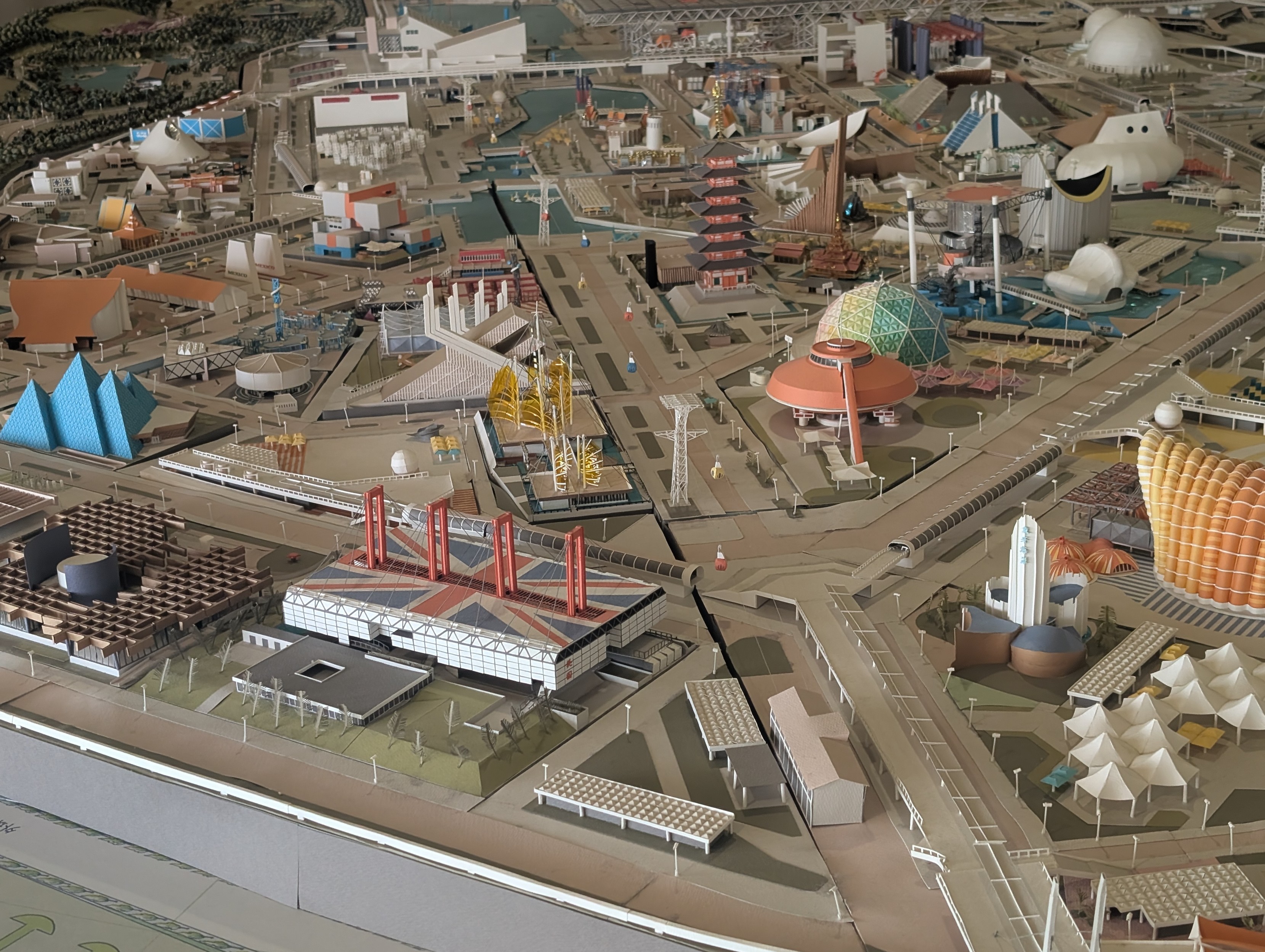 A model of the Expo 70 layout. Prominent in the foreground is the conspicuous UK pagoda, with a massive union jack painted onto the roof. 

I suppose it achieves the goal, since I can't tell you at a glance which other countries are in shot. If you want more info, I suggest looking up the map 