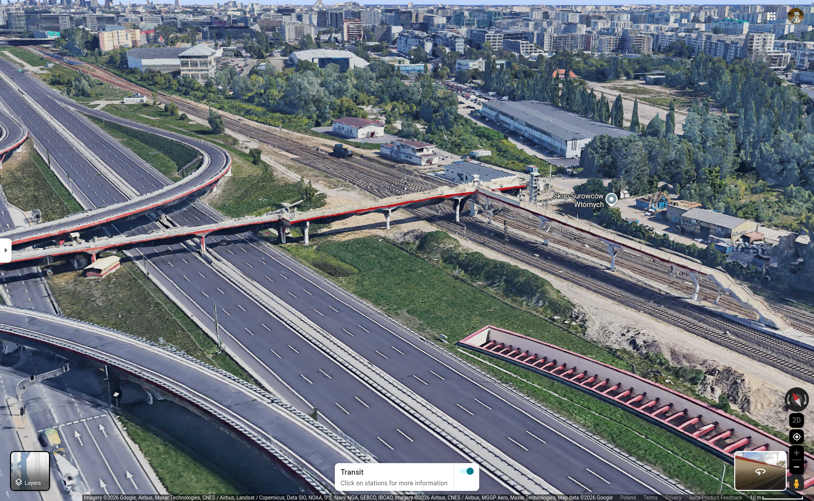 3D view of the Warszawa Okęcie train station, with a viaduct starting at the platform, then extending 100 metres in the same direction as the platform before splitting; then, towards the left it crosses a 6-lane highway and a 4-lane connecting road, before finally descending off the screen down three flights of stairs onto a bus stop