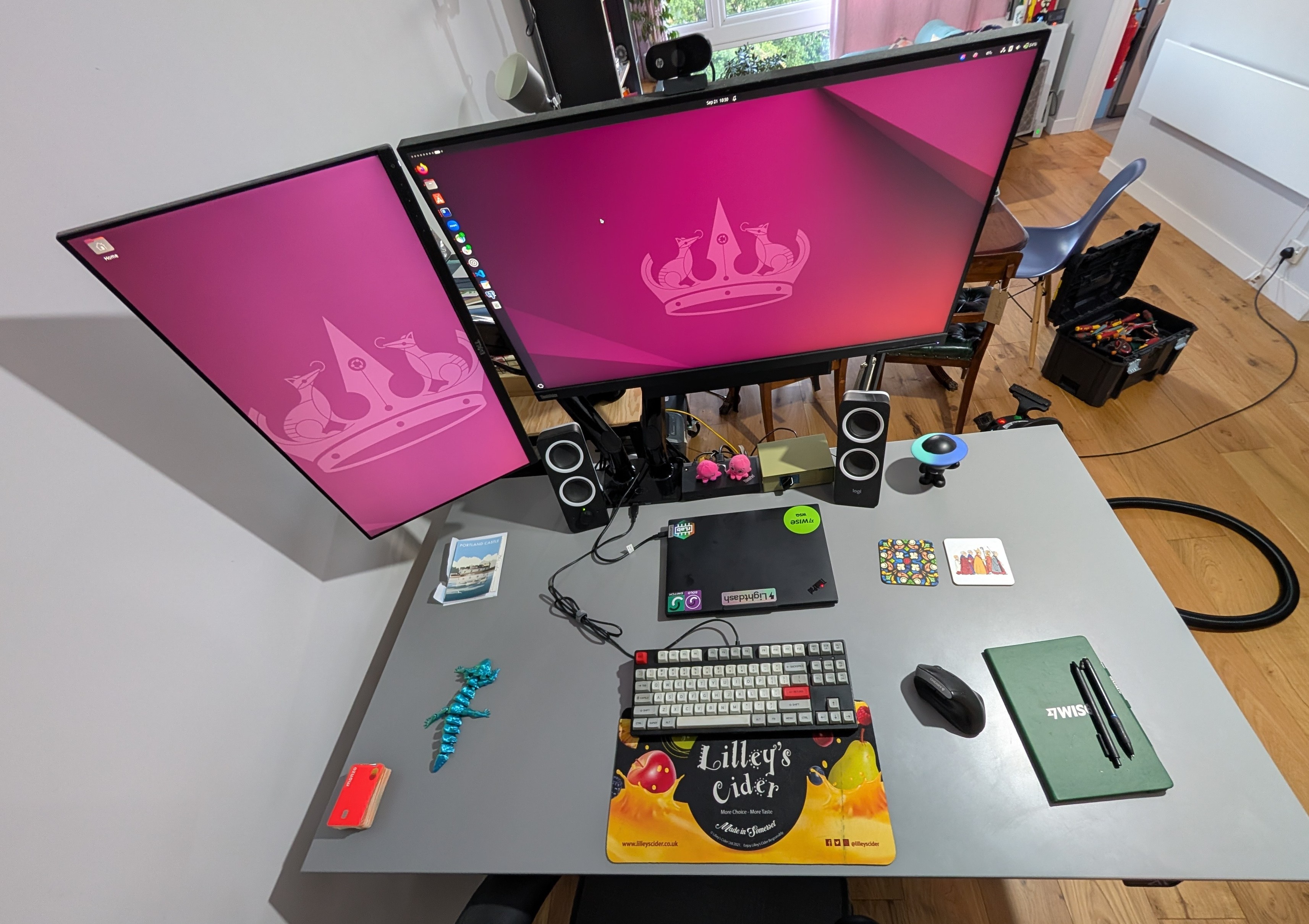 A desk from the top down. It's a Dell monitor mounted vertically and a large 32" ThinkVision in the middle. There's a keyboard, mouse, notebook etc. on the desk A desk from the top down. It's a Dell monitor mounted vertically and a large 32" ThinkVision in the middle. There's a keyboard, mouse, notebook etc. on the desk