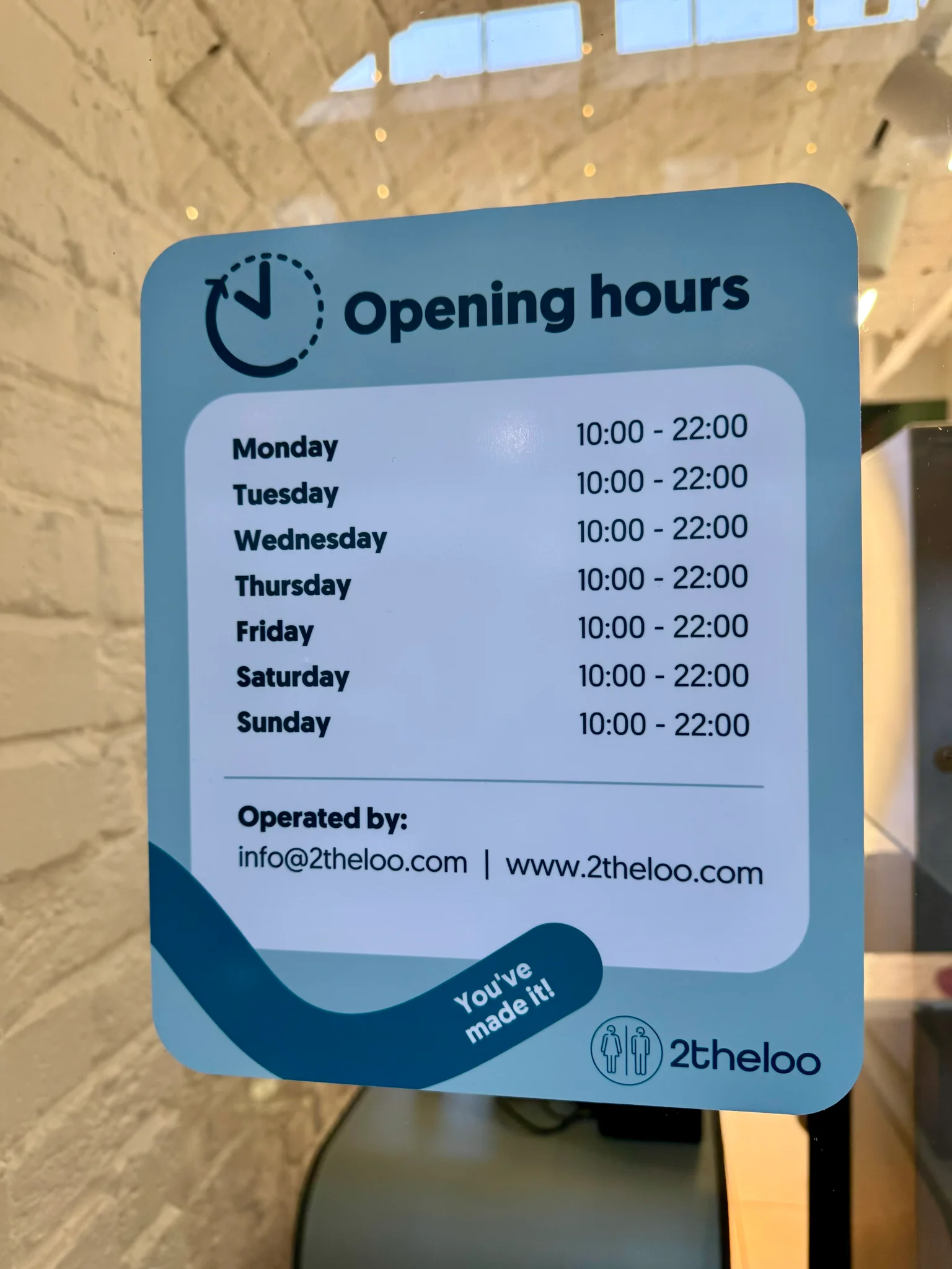 A sign with the opening times of the 2theloo public toilet at Covent Garden