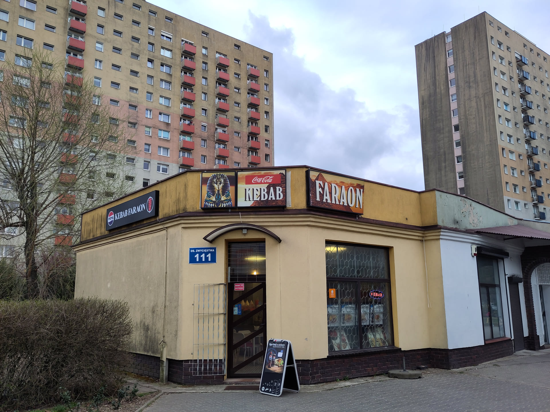 A small bar selling kebab, named Faraon, placed between high block of flats.
