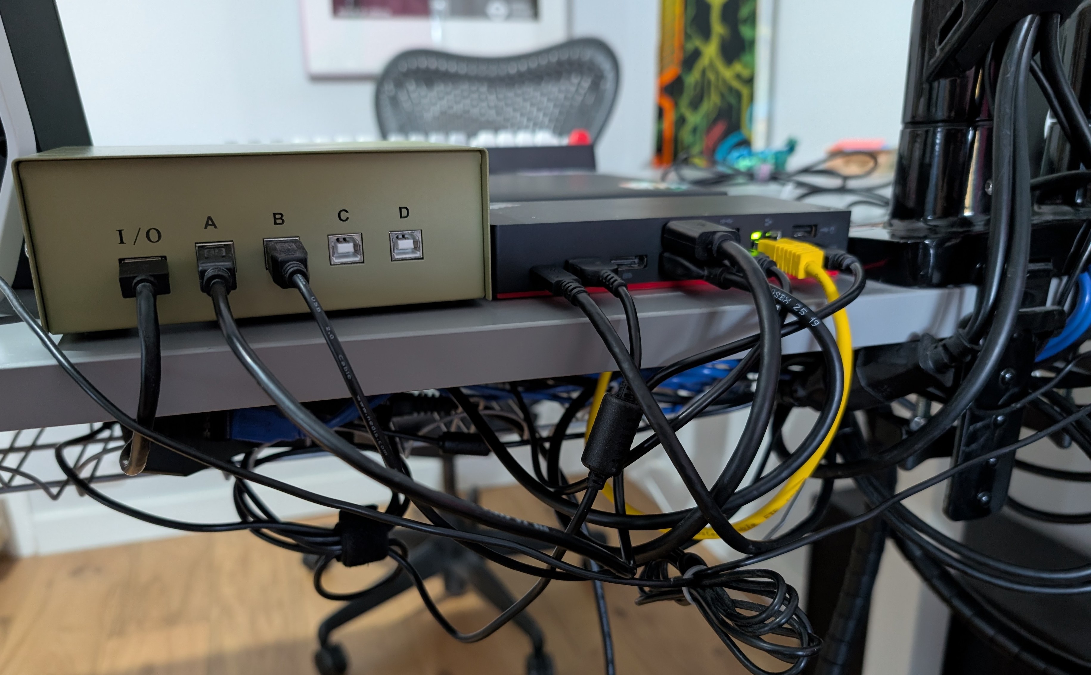 Looking at the back of the USB switcher and the Think Hub thing. There's a lot of cables Looking at the back of the USB switcher and the Think Hub thing. There's a lot of cables