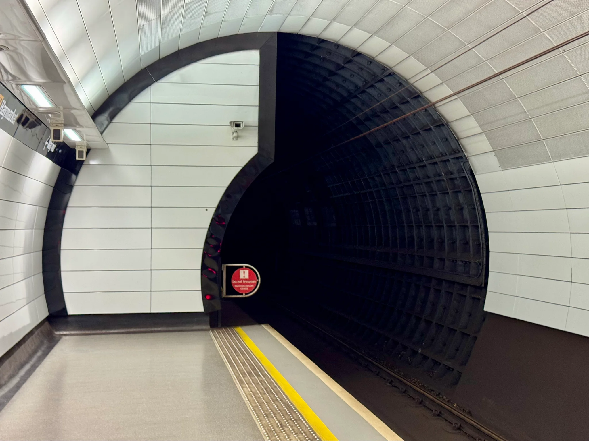 Some smaller cast iron tunnel rings beyond the well-lit platform.