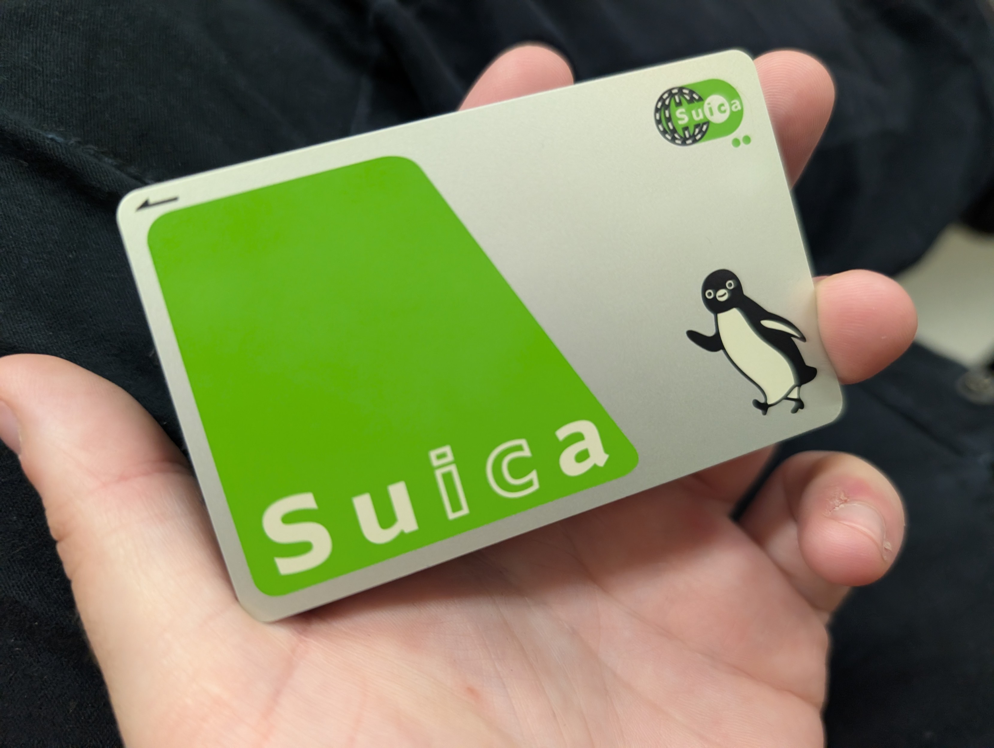Suica card, held in the palm of a hand 
